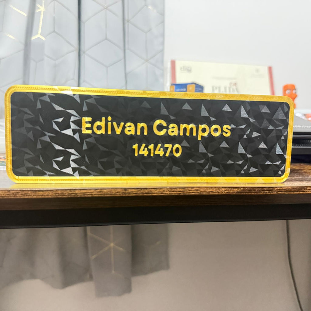 Nameplate with 'Edivan Campos' and number '141470' on a geometric patterned background